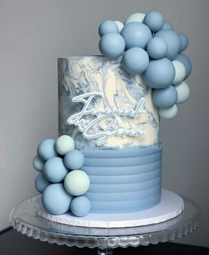 Balloon-adorned blue birthday celebration cake